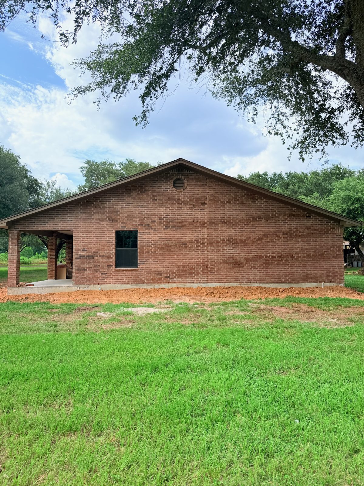 Finished room addition with brick exterior matching the original home