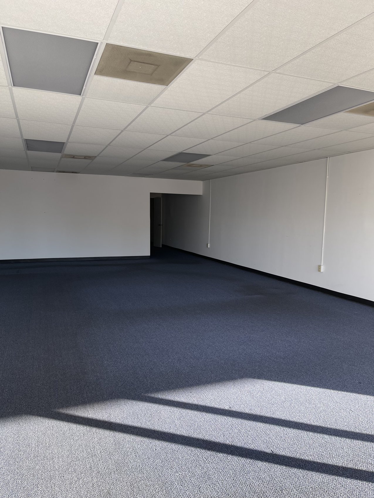 Finished commercial interior room with new carpet, ready for occupancy